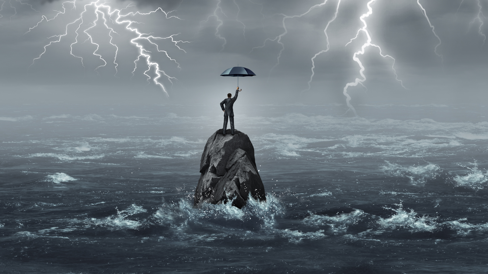 man under umbrella in lightning storm standing on a rock